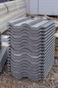 Close-up of stack of firewood on floor against wall