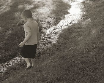 Rear view of man walking on footpath