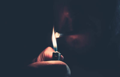 Close-up of man smoking marijuana joint