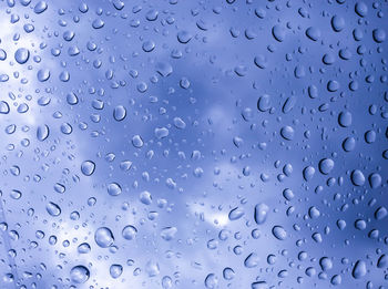 Full frame shot of wet glass window during rainy season