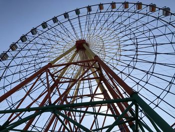 Low angle view of ferris wheel against sky