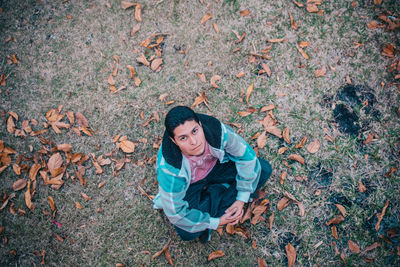 High angle portrait of smiling young woman in field