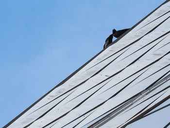 Low angle view of roof against clear blue sky