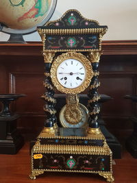 Close-up of illuminated clock on table in building