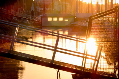 Bridge over river against sky during sunset