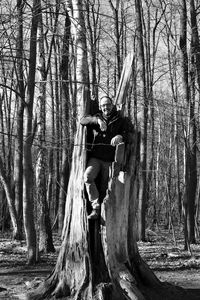 Man standing by trees in forest