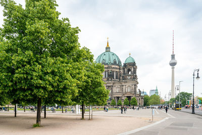 Berlin cathedral by fernsehturm tower against sky