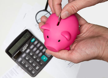 Close-up of hand holding piggy bank
