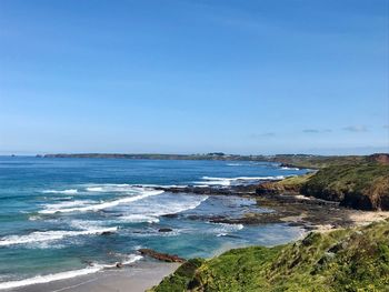 Scenic view of sea against blue sky