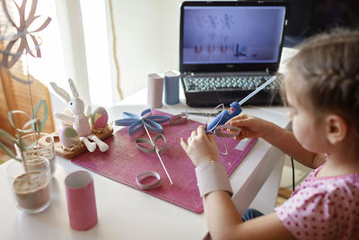 Close-up of girl doing craft at home