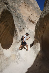 Low angle view of woman on rock