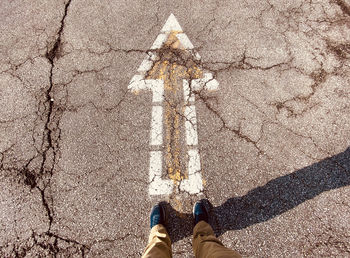 Low section of person standing on road