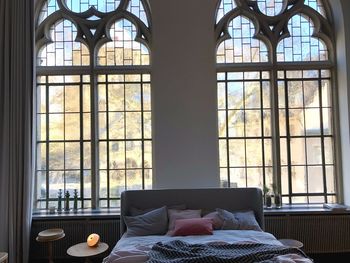 People relaxing on table by window at home