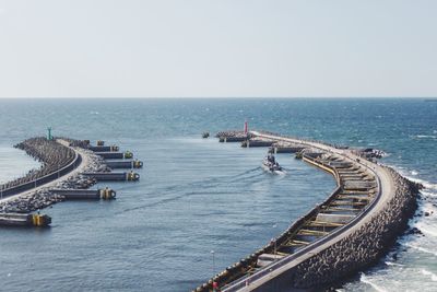 High angle view of boats in sea against clear sky
