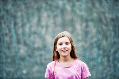 Portrait of happy girl standing in park