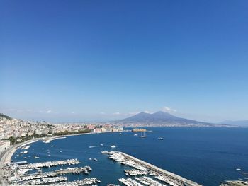 High angle view of bay and city against clear blue sky