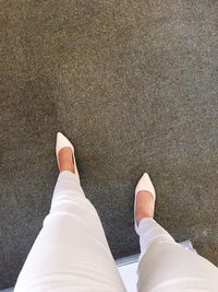 Low section of woman standing on tiled floor