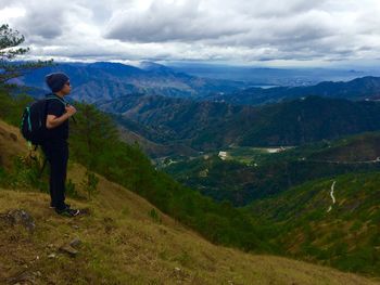 Rear view of man hiking on mountain