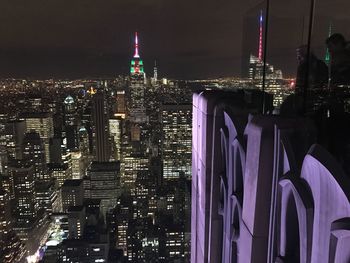 Aerial view of city lit up at night