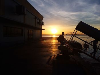 Silhouette people at port of cebu during sunrise