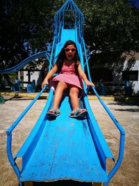 Full length portrait of happy girl playing in park