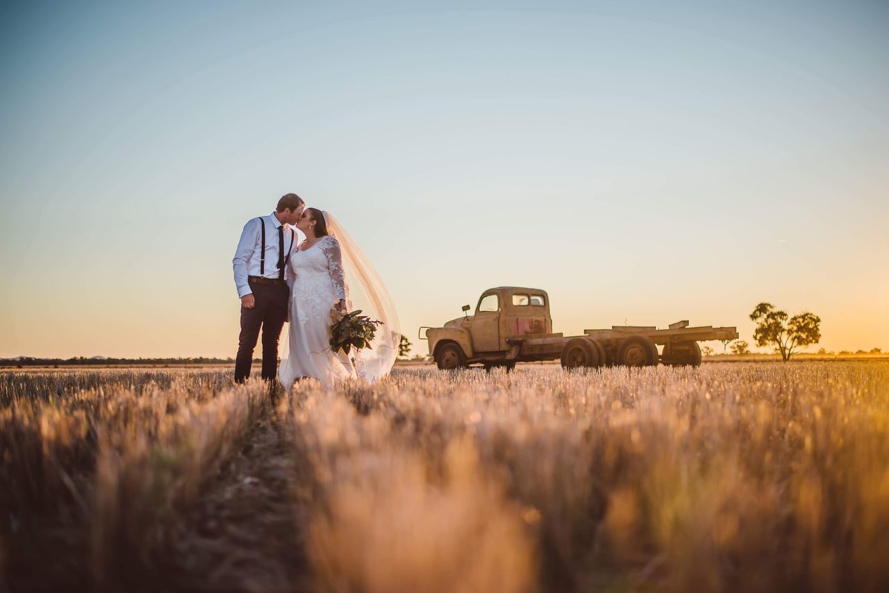 two people, field, real people, land, togetherness, plant, adult, men, nature, sky, couple - relationship, positive emotion, leisure activity, bonding, love, sunlight, standing, lifestyles, young adult, casual clothing, outdoors