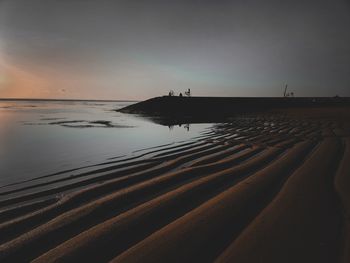 Scenic view of beach against sky during sunset