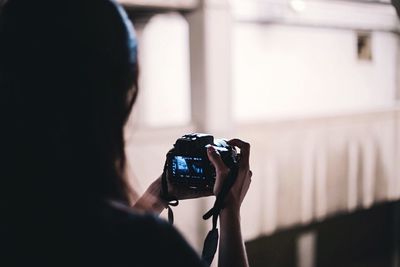 Rear view of woman photographing