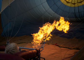 Woman inflating hot air balloon on field