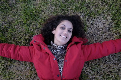 Portrait of smiling woman lying on field