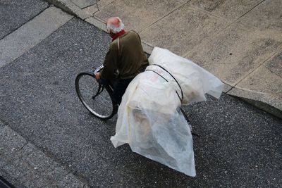 High angle view man riding on a bike at street