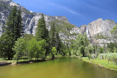 Scenic view of trees and mountains against sky