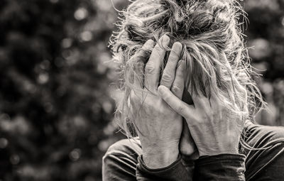 Close-up of depressed woman touching face