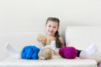 Portrait of smiling boy sitting on sofa