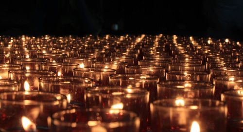Lit tea light candles in temple