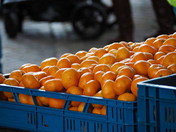 Close-up of oranges in basket for sale at market stall