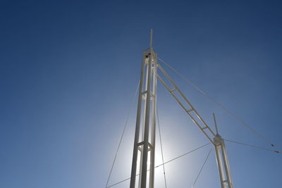 Low angle view of wind turbine against blue sky