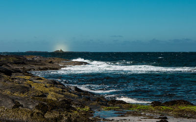 Scenic view of sea against clear blue sky