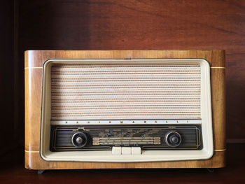 Vintage radio on table against wall