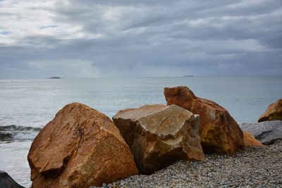 Rocks on shore against sky