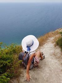 High angle view of woman sitting on beach