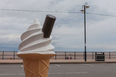 Close-up of ice cream sculpture at promenade against sky