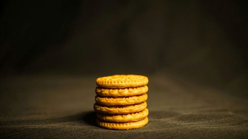 Close-up of stack on table against black background