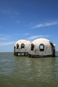 View of building by sea against sky