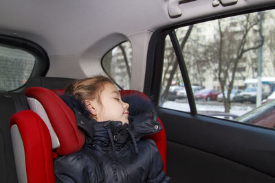 Girl sleeping with sitting in car