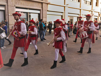 Group of people walking on street in city