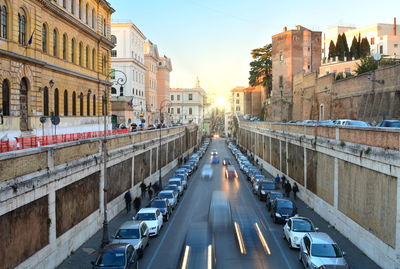 Traffic on road amidst buildings in city