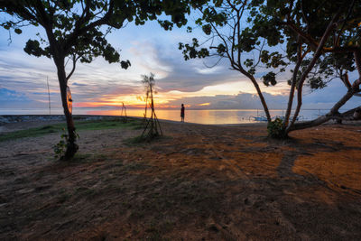 Scenic view of beach against sky during sunset