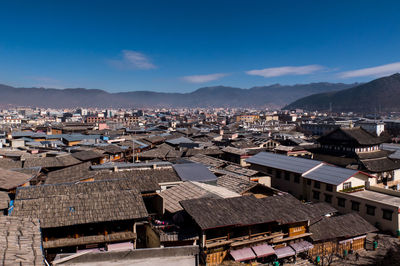 High angle view of townscape against blue sky