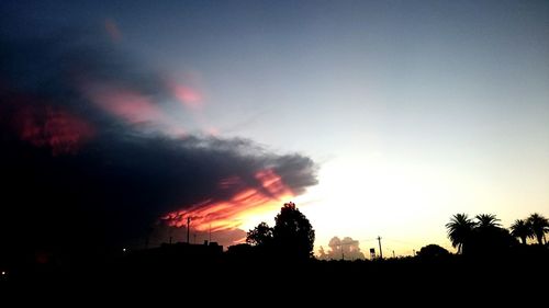 Silhouette landscape against sky at sunset